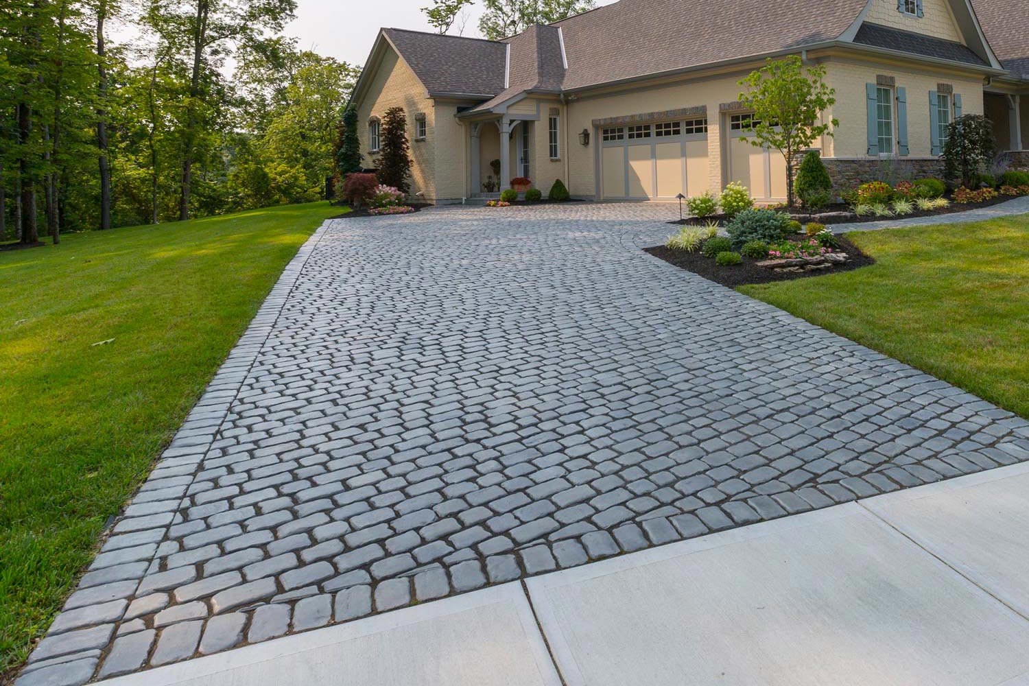 Brick paver driveway installation showing herringbone pattern at Minnesota home